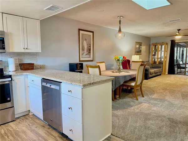 a view of a livingroom with furniture and a flat screen tv