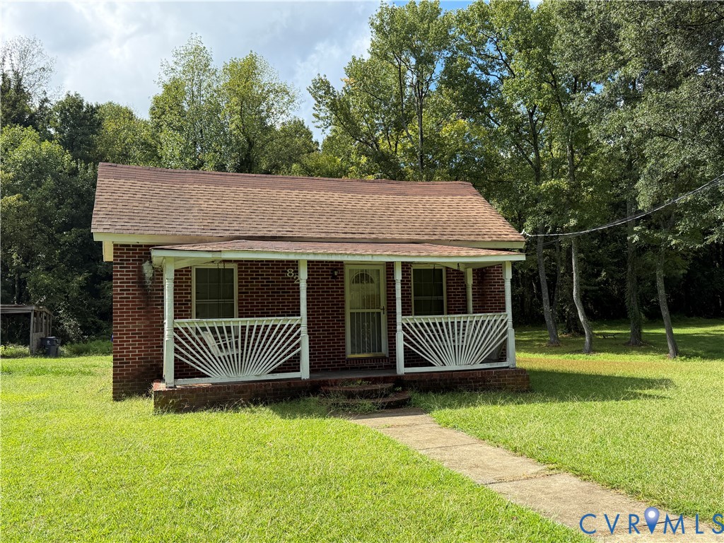 Brick exterior with a covered front porch featurin