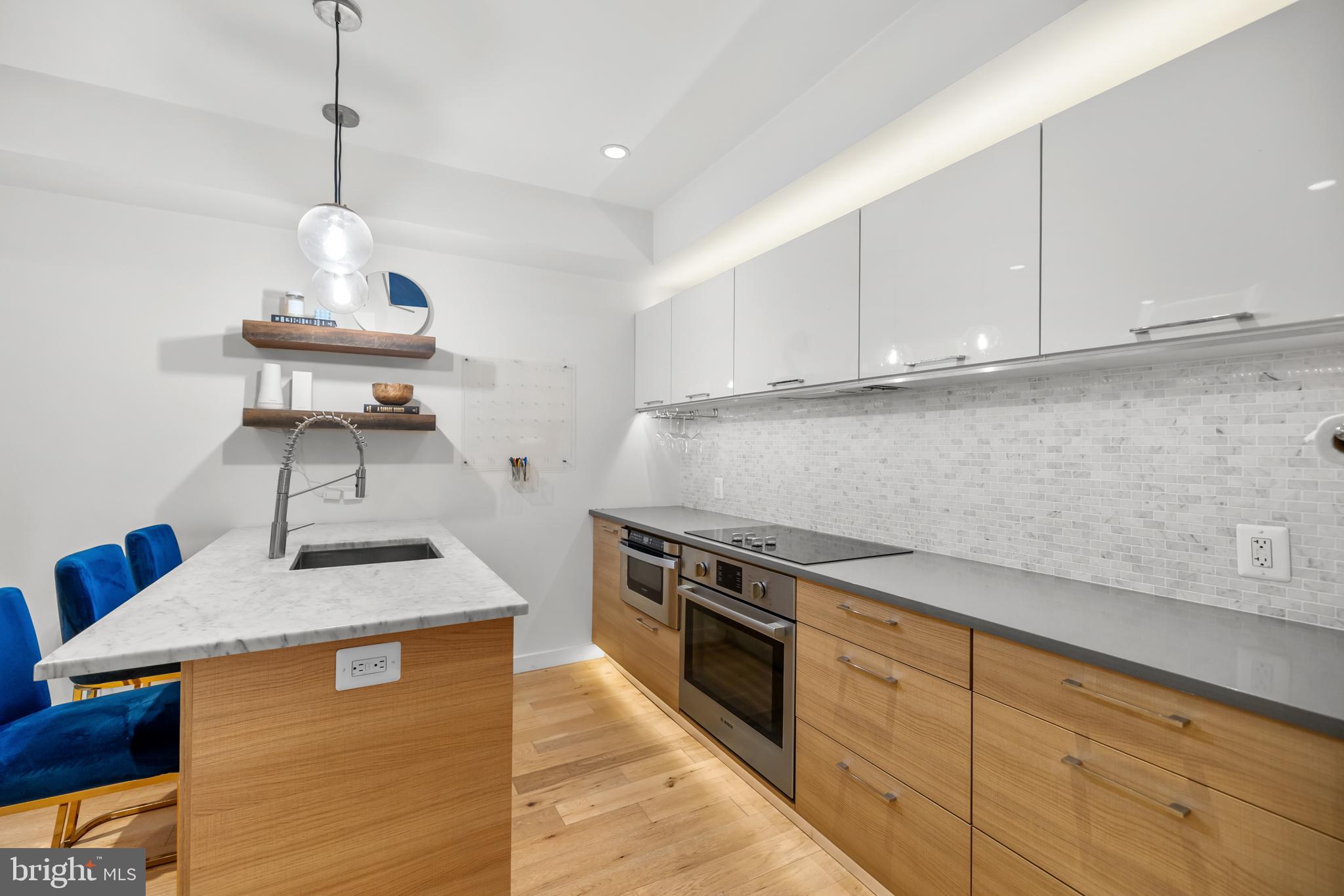 1324 W Street Northwest, Unit 1 Washington, DC 20009 - Photo 10 of 37 a kitchen with stainless steel appliances granite countertop a sink a stove and a wooden floors