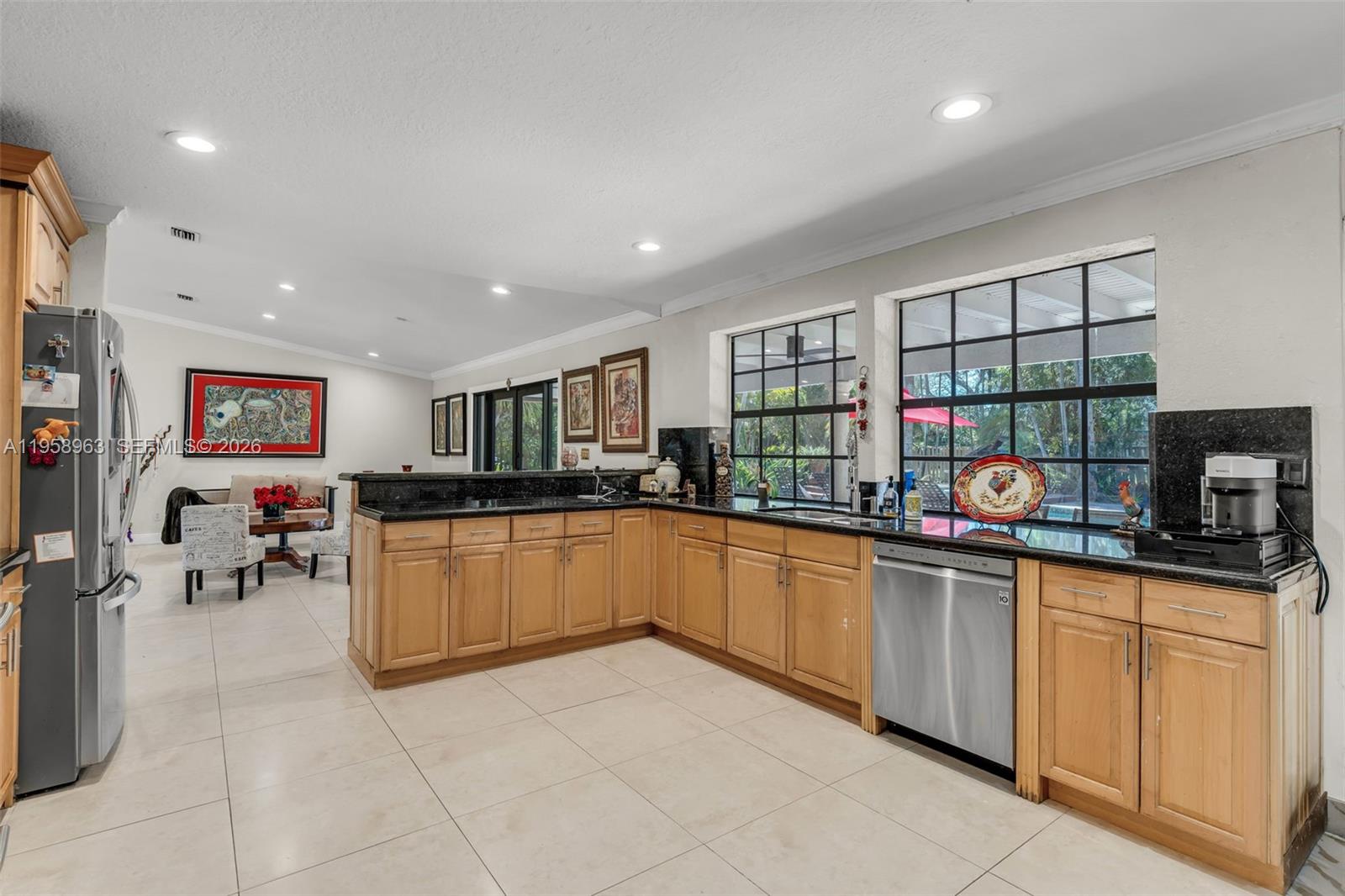 16564 Southwest 153rd Court Miami, FL 33187 - Photo 11 of 45 a kitchen with stainless steel appliances granite countertop a sink and cabinets