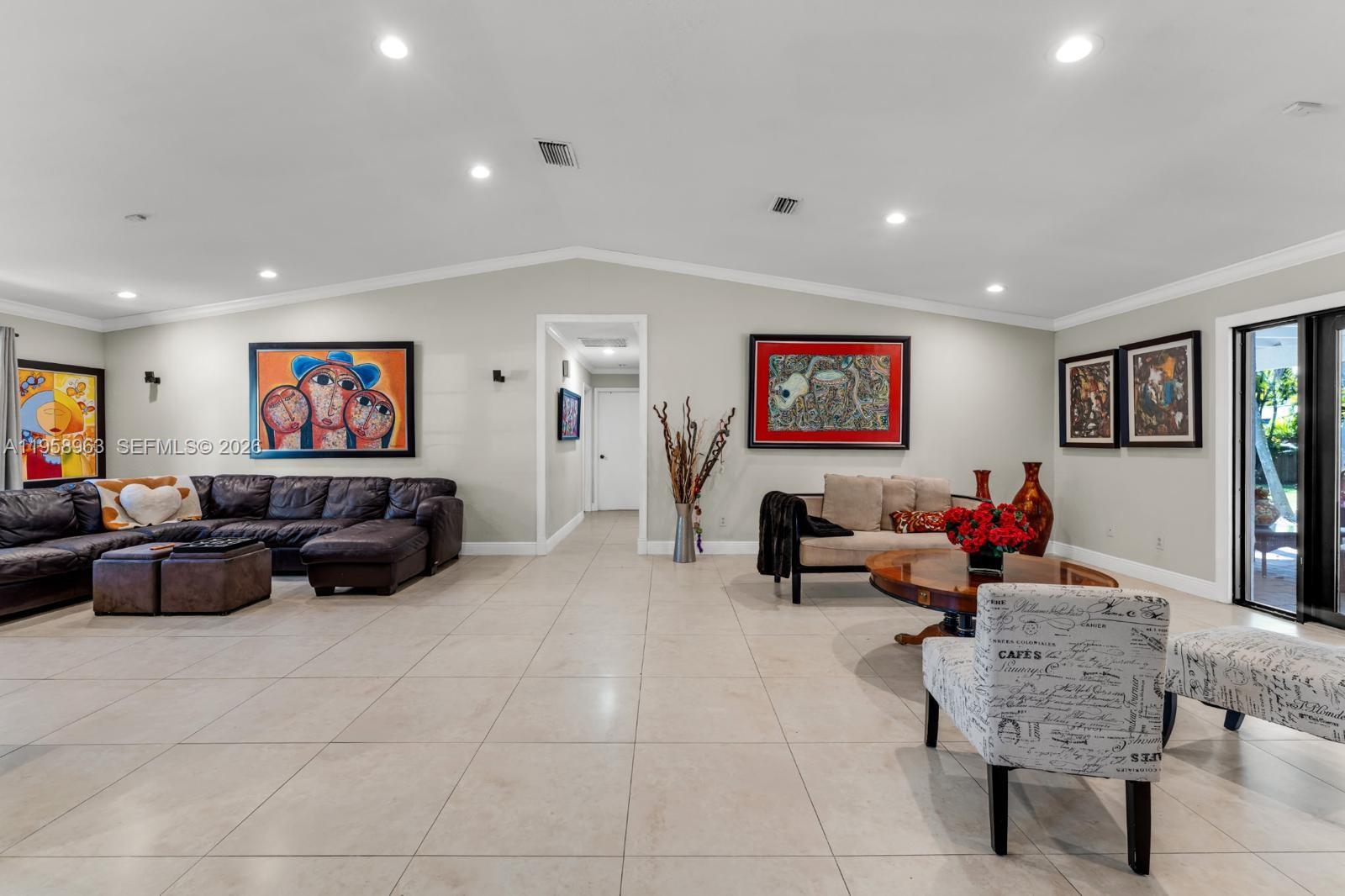 16564 Southwest 153rd Court Miami, FL 33187 - Photo 8 of 45 a living room with furniture and a flat screen tv