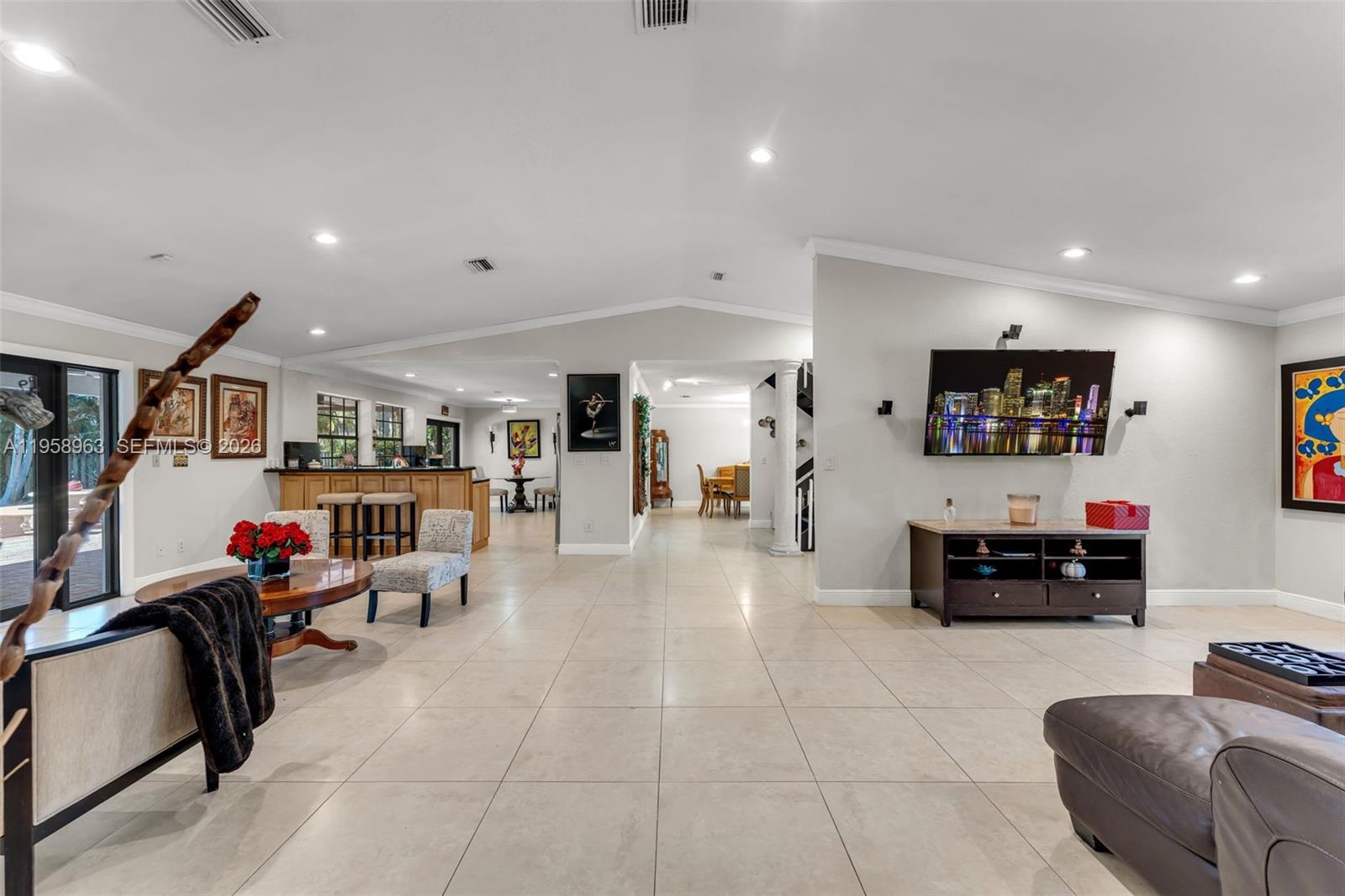 16564 Southwest 153rd Court Miami, FL 33187 - Photo 9 of 45 a living room with furniture and a flat screen tv