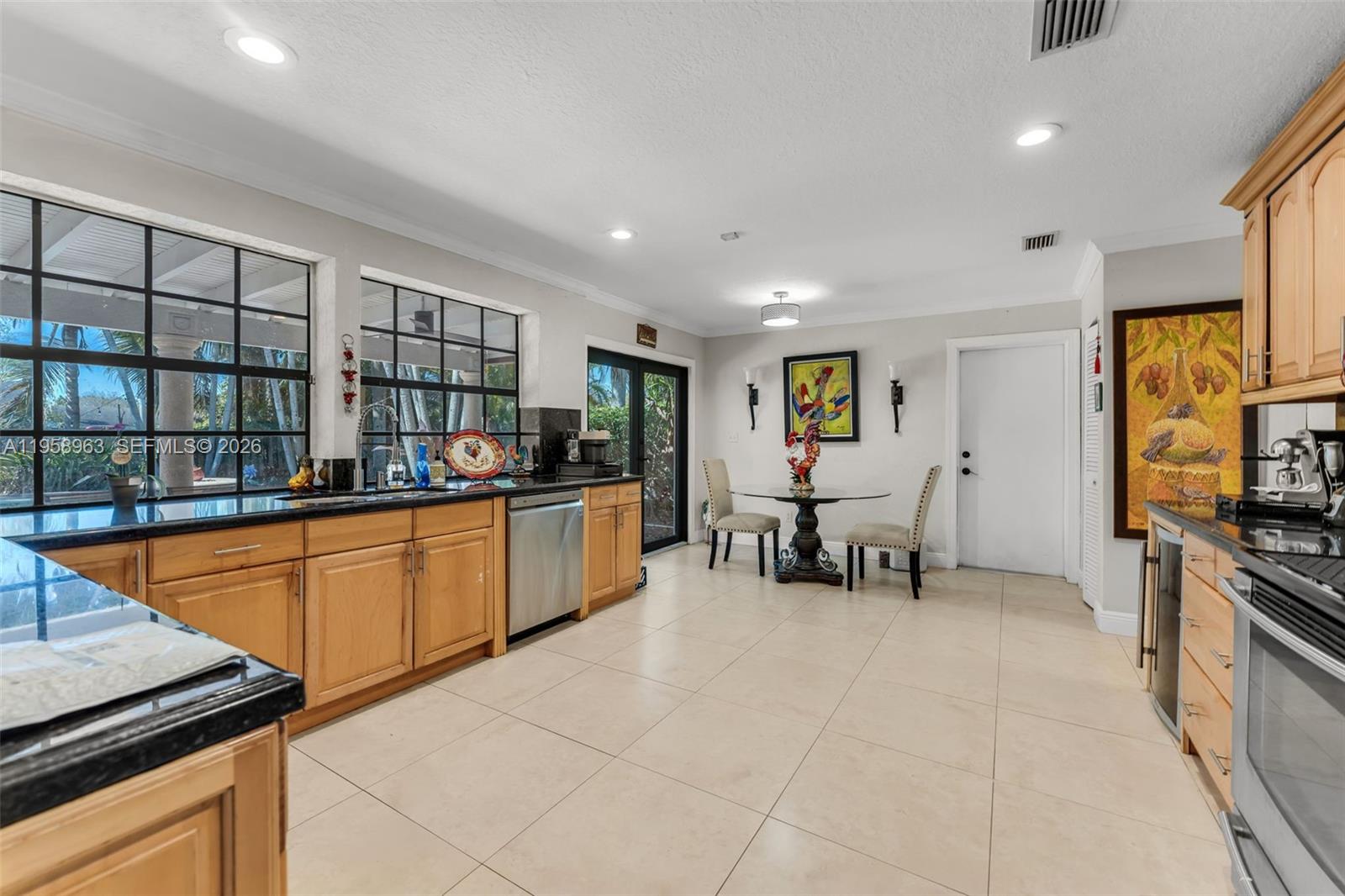 16564 Southwest 153rd Court Miami, FL 33187 - Photo 10 of 45 a kitchen with stainless steel appliances granite countertop a stove and a sink