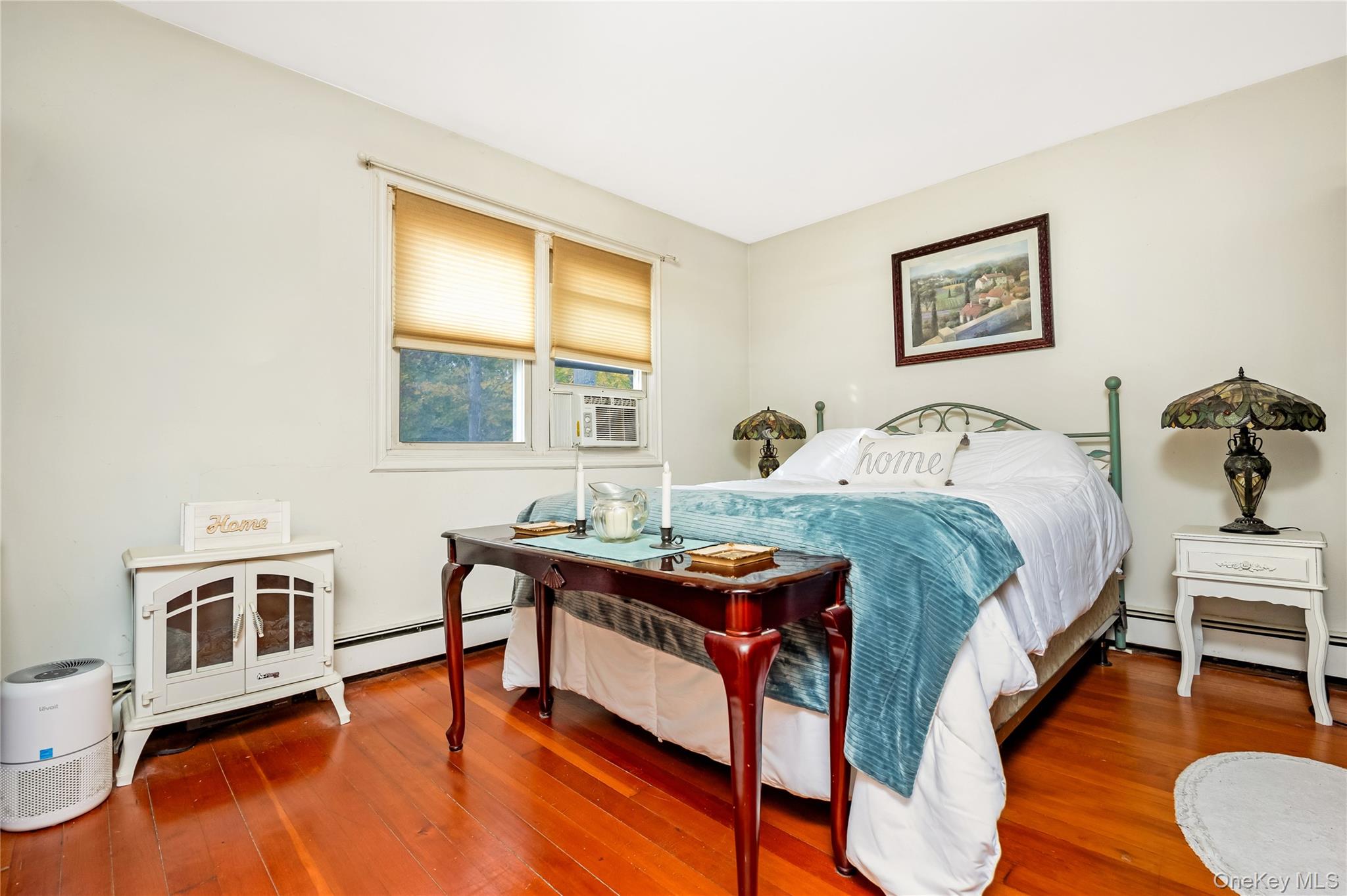180 Lakeside Trail Ridge, NY 11961 - Photo 14 of 22 a bedroom with a bed dresser and wooden floor