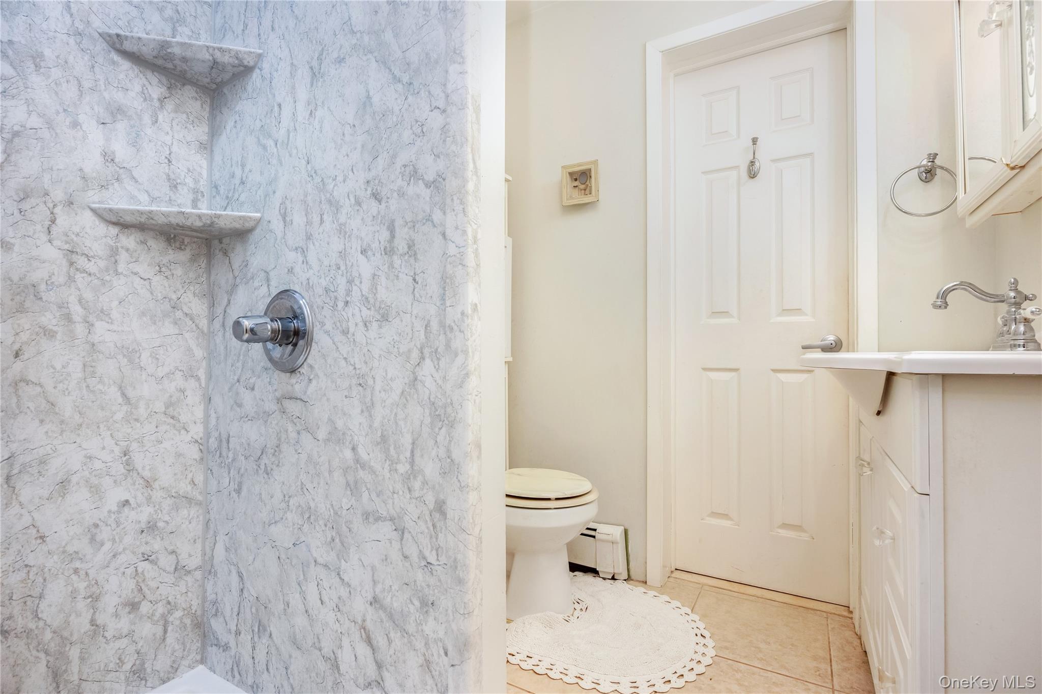 180 Lakeside Trail Ridge, NY 11961 - Photo 16 of 22 a bathroom with a toilet and a shower