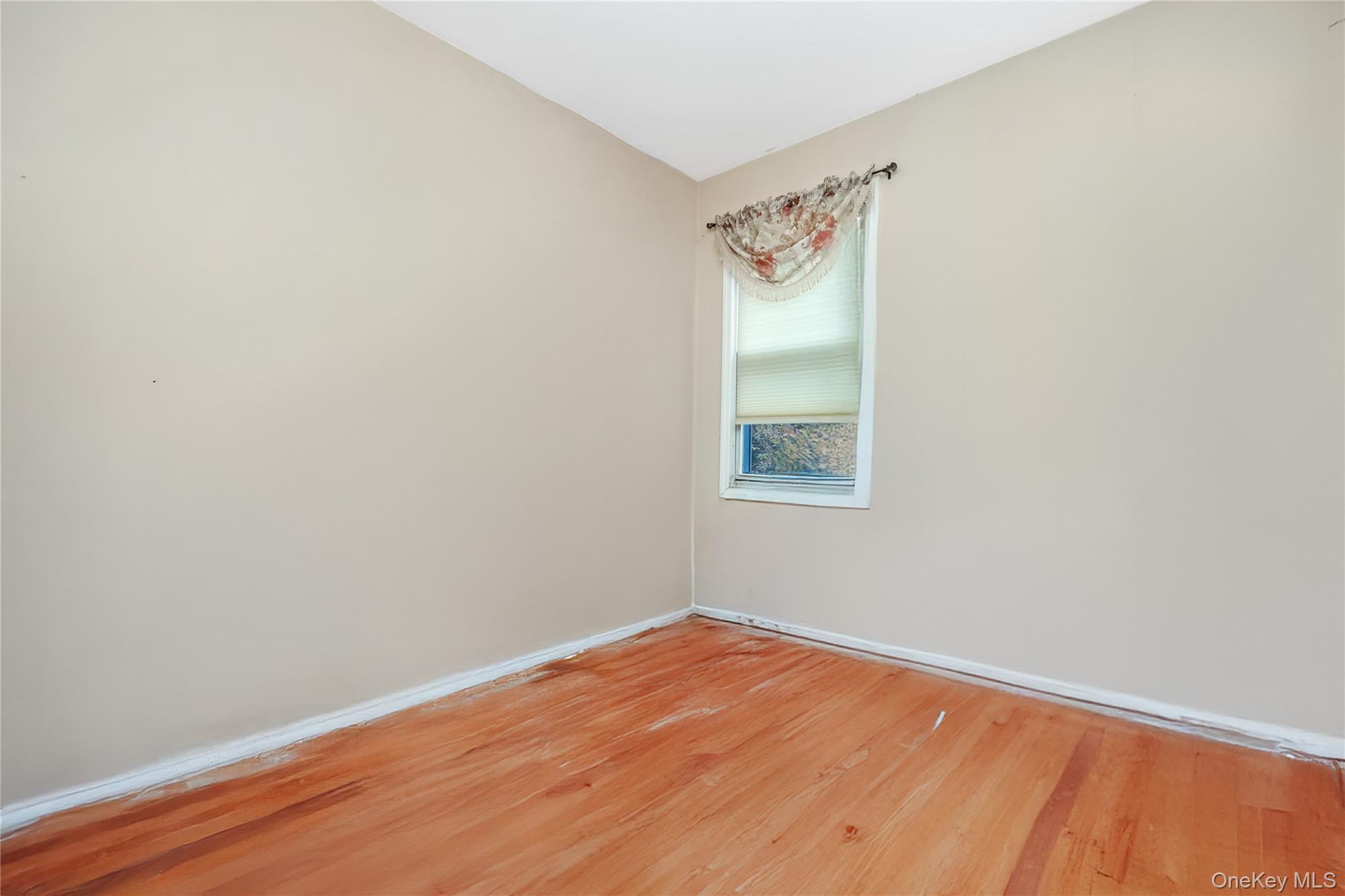 180 Lakeside Trail Ridge, NY 11961 - Photo 18 of 22 a view of a room with wooden floor and white walls