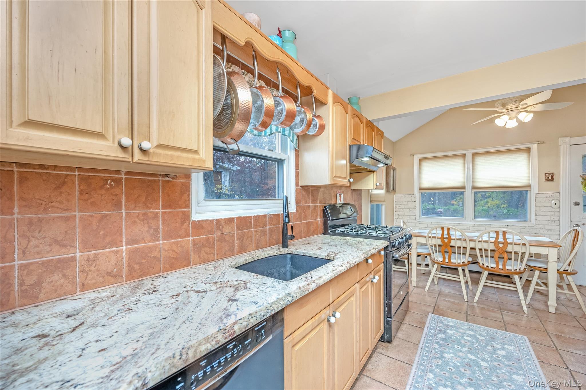 180 Lakeside Trail Ridge, NY 11961 - Photo 4 of 22 a view of a kitchen with granite countertop a sink and a wooden floor