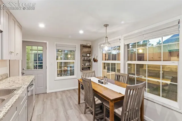 a view of a dining room with furniture window and wooden floor