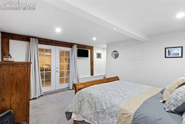 a bedroom with a large bed and a large window