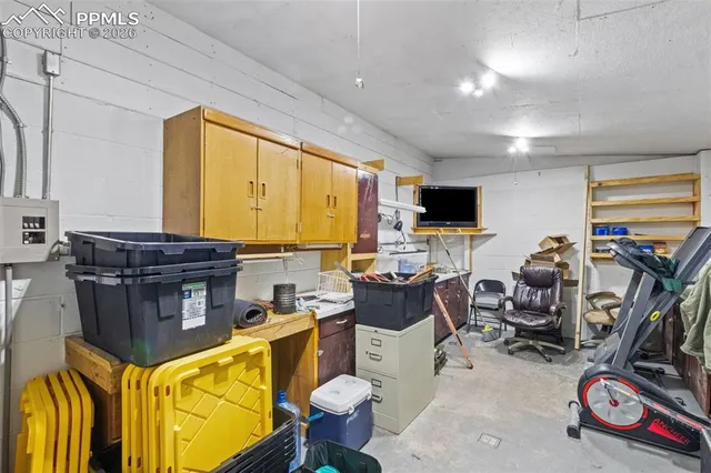 a view of a workspace with furniture and a flat screen tv