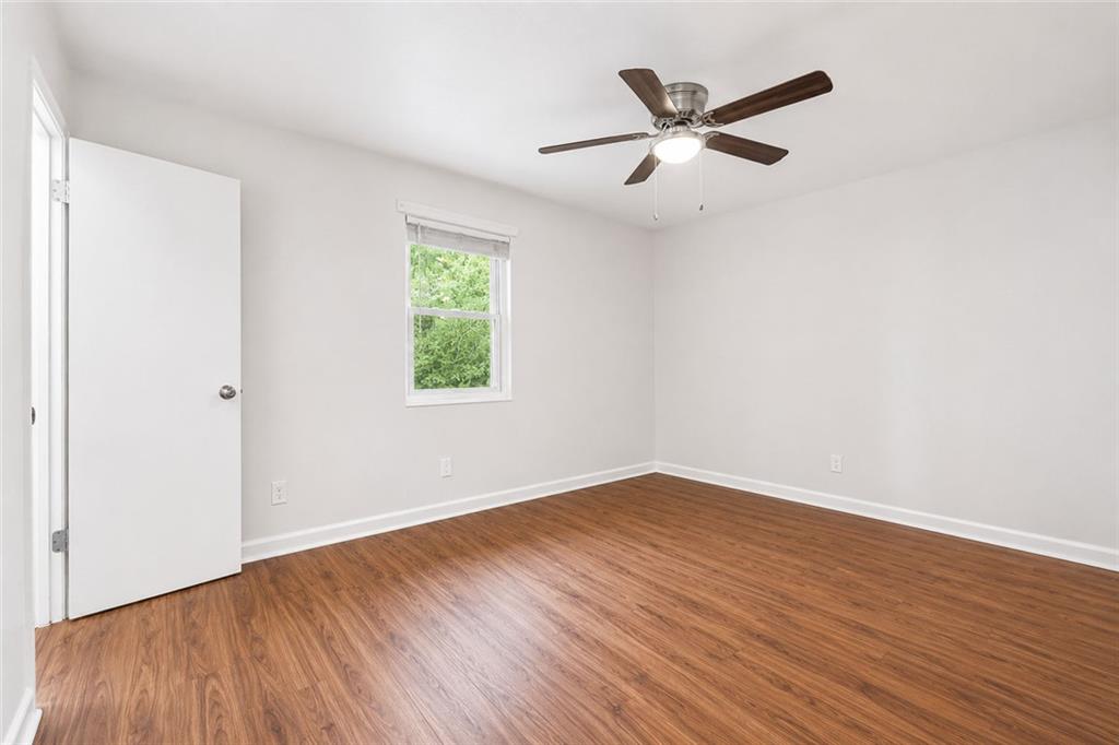 3203 East Point Street, Unit 4 Atlanta, GA 30344 - Photo 11 of 18 an empty room with wooden floor and a ceiling fan