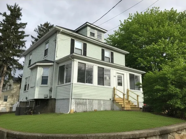 a front view of a house with a garden
