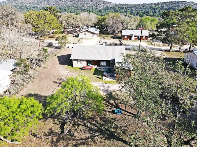 a view of a house with backyard and sitting area