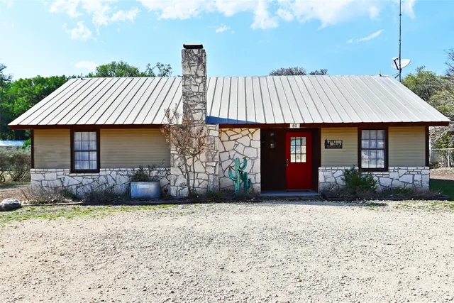 a view of a house with swimming pool and sitting area