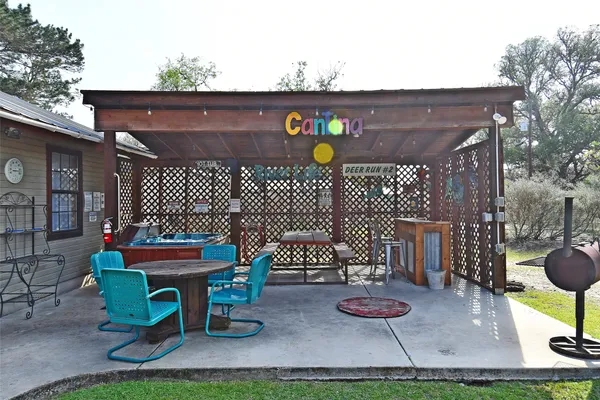 a view of a house with backyard porch and sitting area