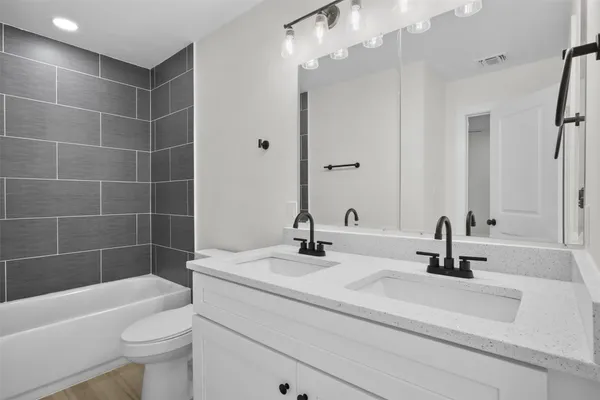 a bathroom with a sink a toilet and bathtub