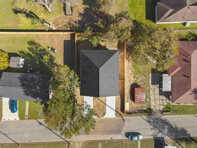 an aerial view of a house with a yard