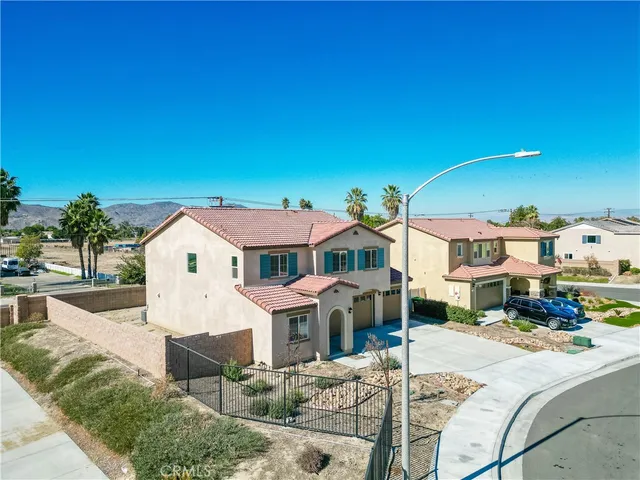 an aerial view of a house with a swimming pool