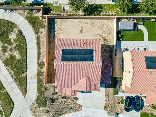 an aerial view of a house with a garden and lake view