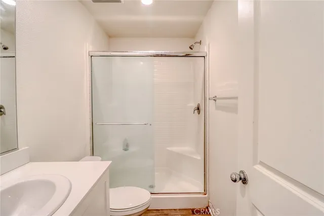 a kitchen with granite countertop white cabinets and stainless steel appliances