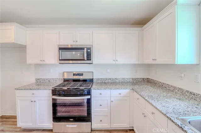 a kitchen with a sink stove and cabinets