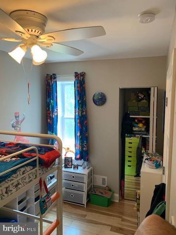 a bedroom with furniture and a wooden floor