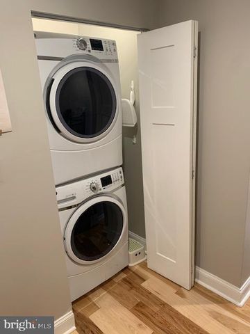 a view of a hallway with washer and dryer