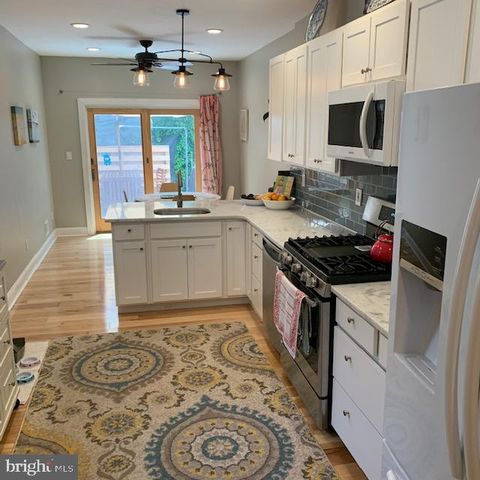 a kitchen with a stove a sink and a microwave