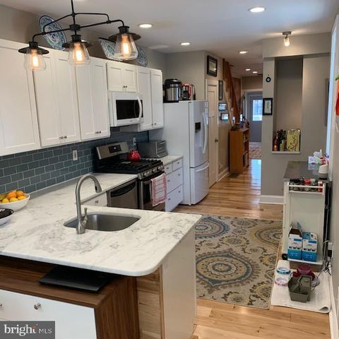 a kitchen with stainless steel appliances granite countertop a sink refrigerator and microwave