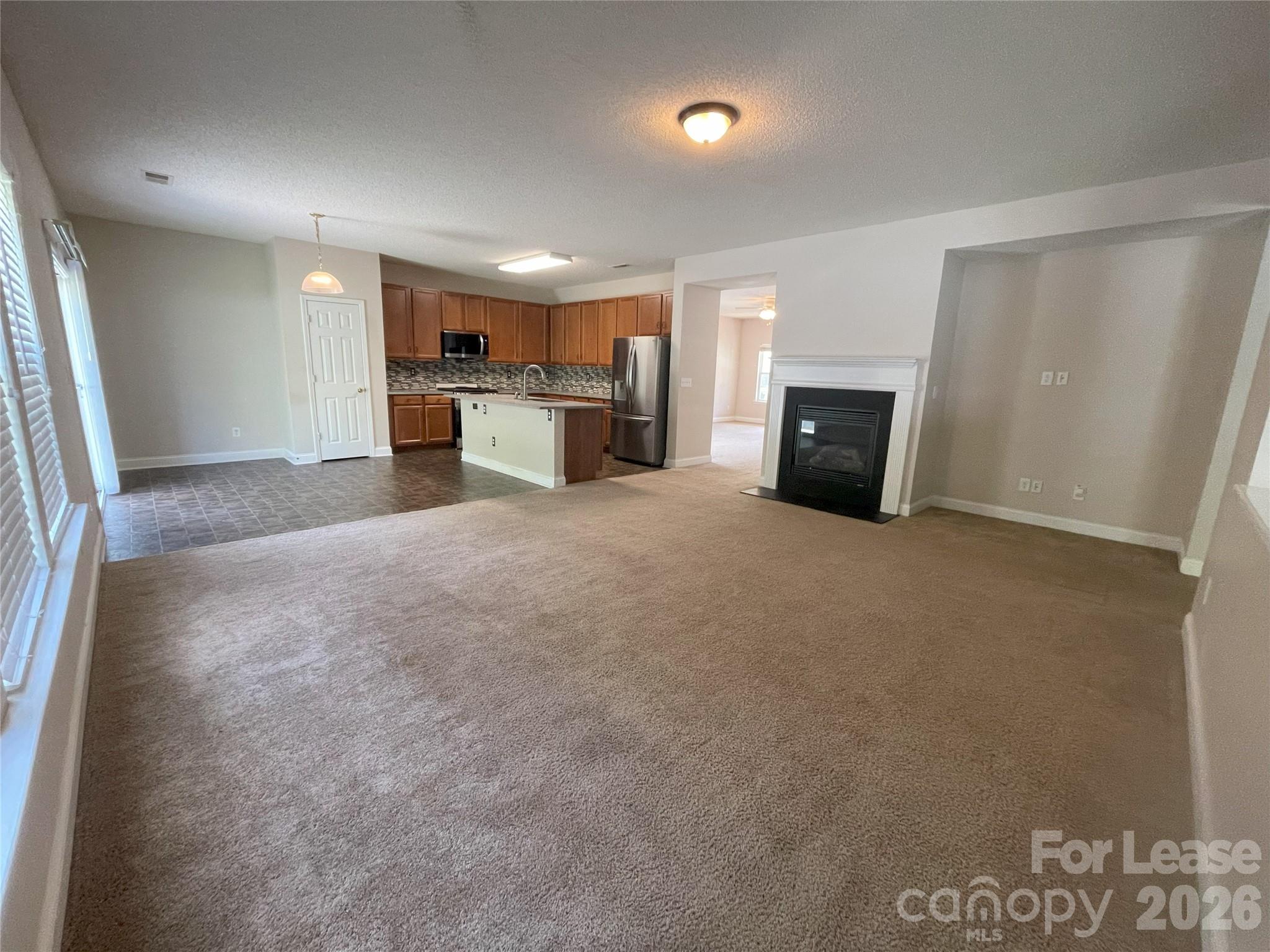 4532 Brookwood Road Charlotte, NC 28215 - Photo 3 of 11 a view of a kitchen with a sink cabinets and a fireplace