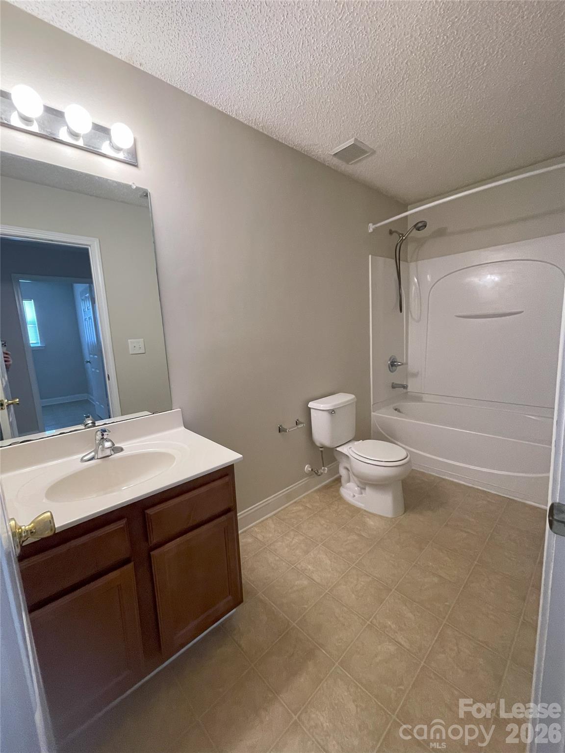 4532 Brookwood Road Charlotte, NC 28215 - Photo 9 of 11 a bathroom with a sink a toilet and a mirror