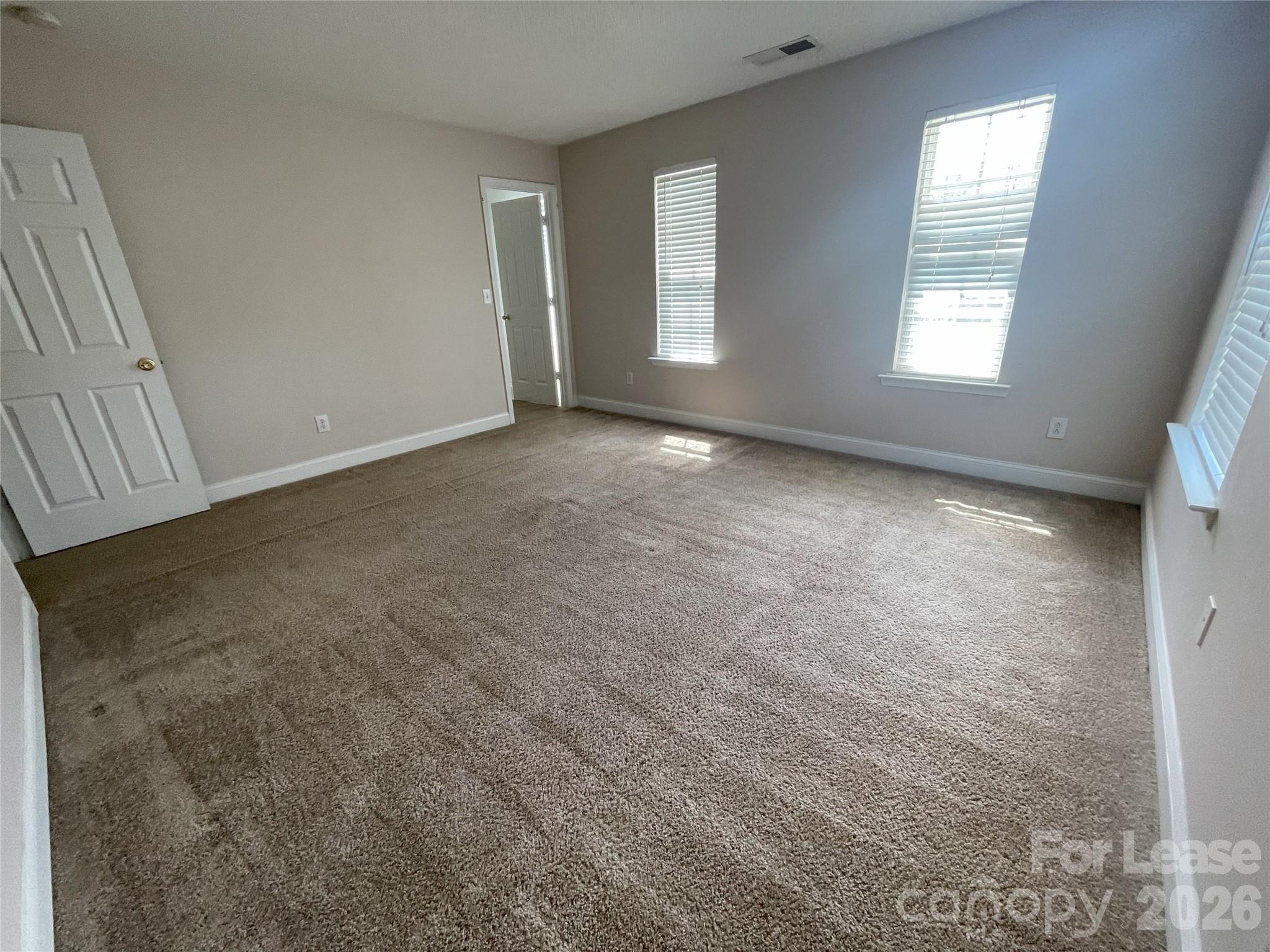 4532 Brookwood Road Charlotte, NC 28215 - Photo 10 of 11 an empty room with windows