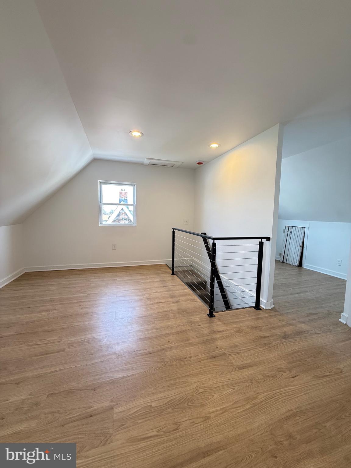 2125 1/2 Oakland Road Baltimore, MD 21220 - Photo 13 of 18 a view of a hall with wooden floor and a rug