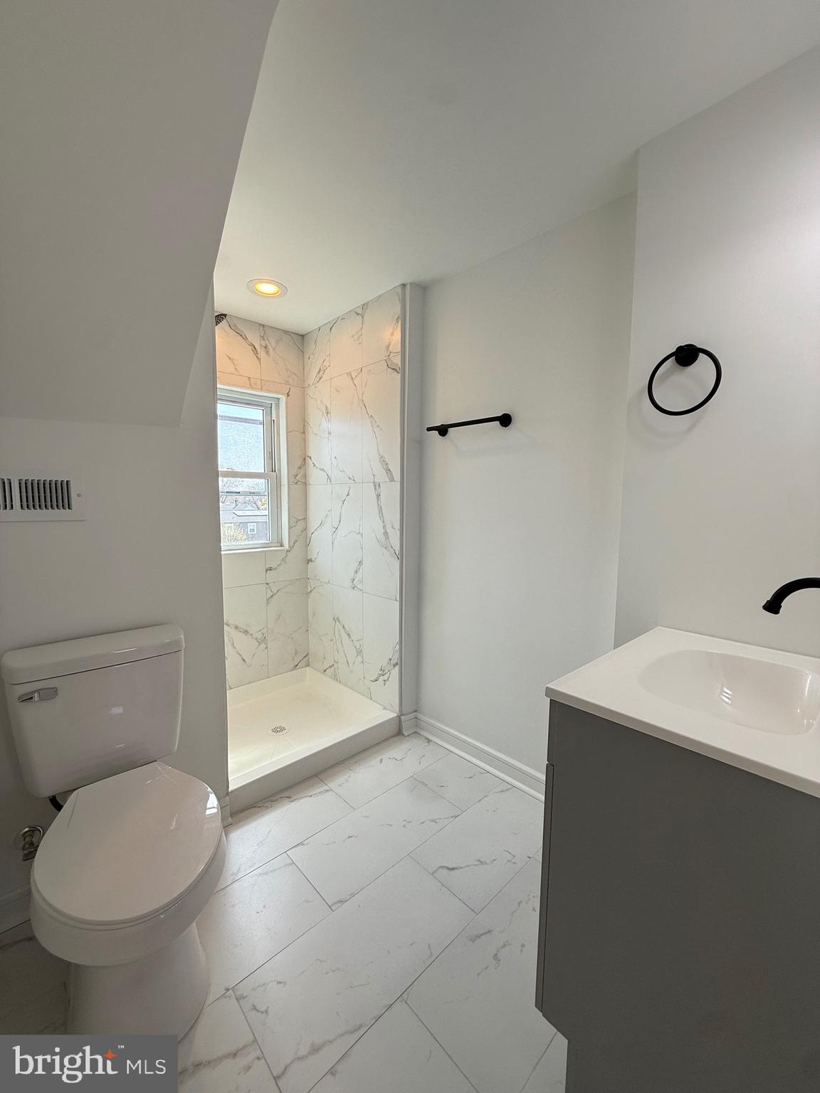 2125 1/2 Oakland Road Baltimore, MD 21220 - Photo 14 of 18 a bathroom with a toilet a sink and shower