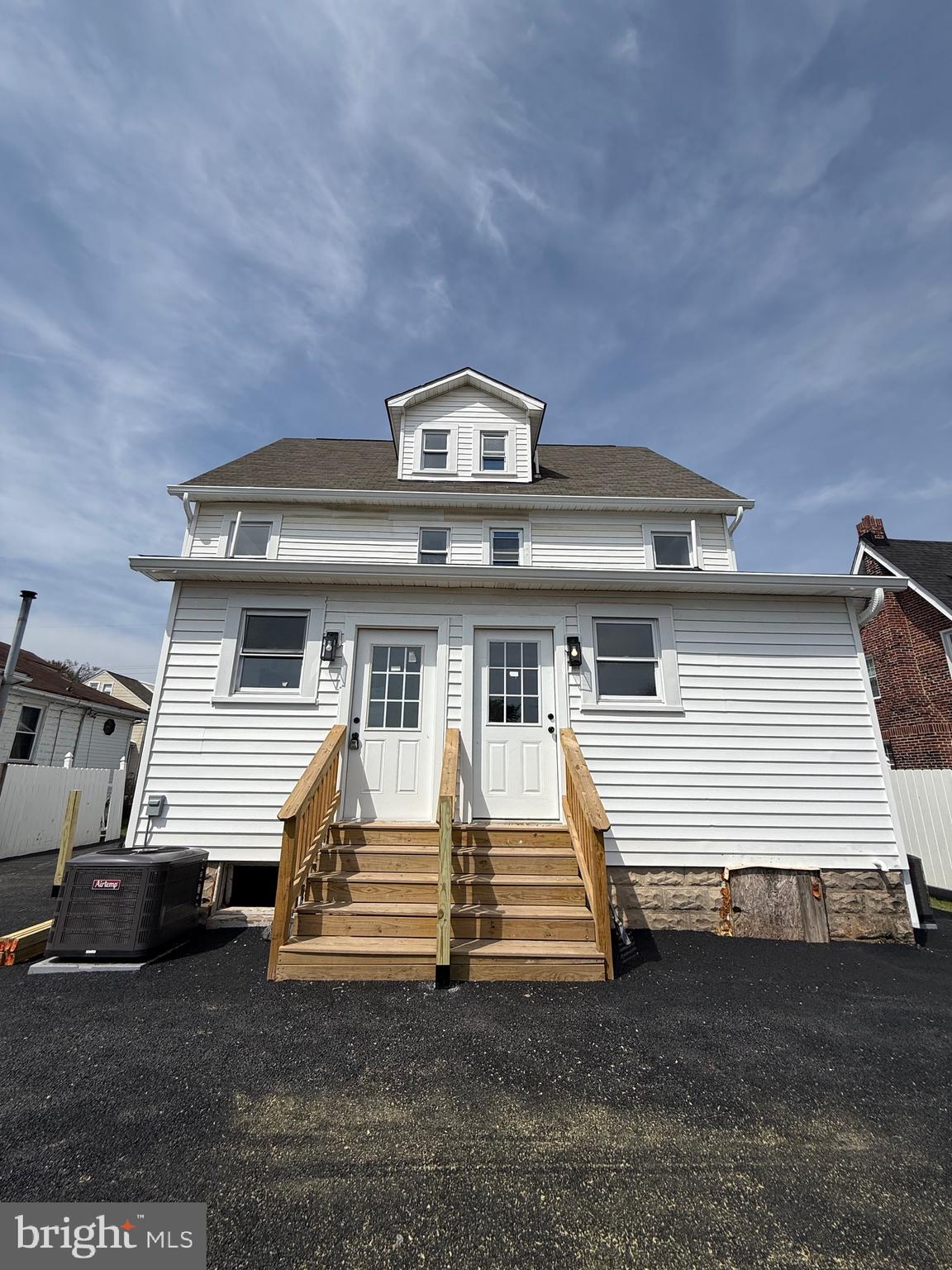 2125 1/2 Oakland Road Baltimore, MD 21220 - Photo 2 of 18 a front view of a house with a yard