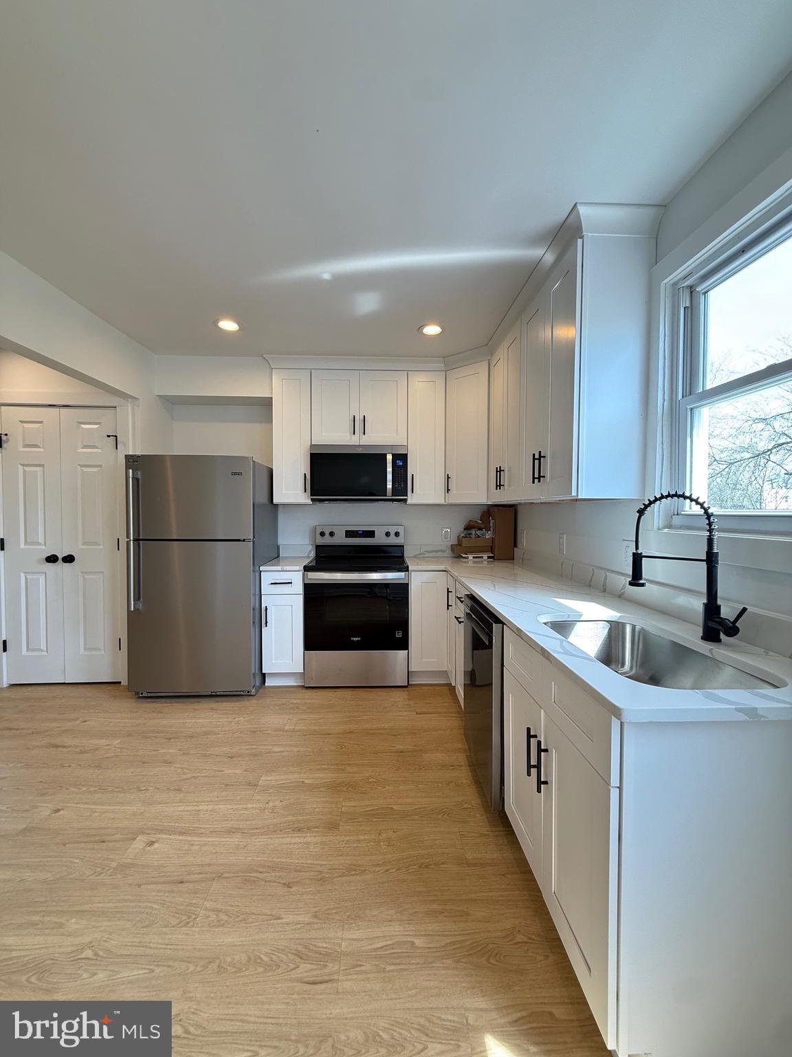 2125 1/2 Oakland Road Baltimore, MD 21220 - Photo 6 of 18 a kitchen with stainless steel appliances granite countertop a sink and a refrigerator
