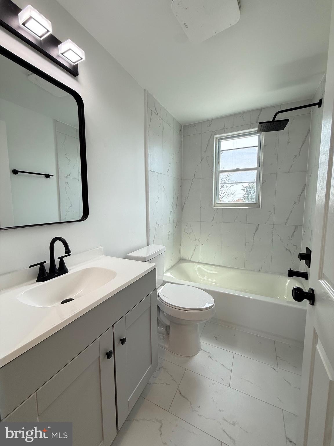 2125 1/2 Oakland Road Baltimore, MD 21220 - Photo 9 of 18 a bathroom with a sink a toilet and shower