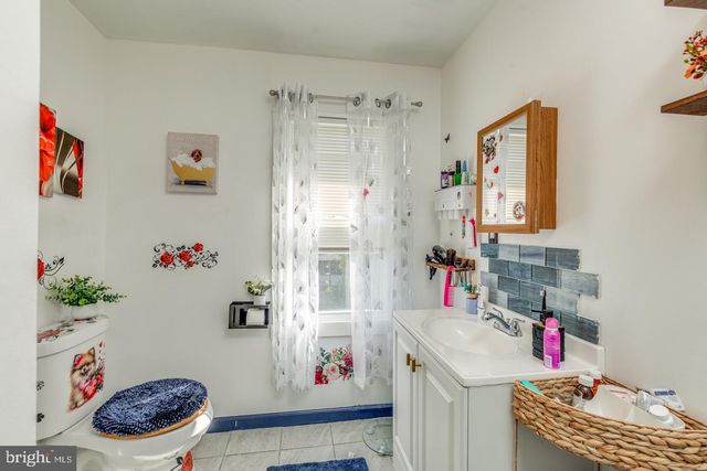 a bathroom with a sink mirror and window