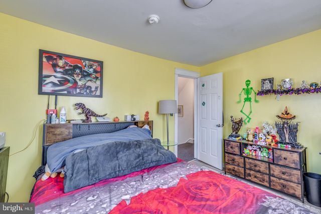 a bedroom with bed and wooden floor