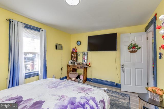 a bedroom with a bed and flat screen tv