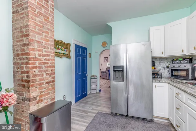 a kitchen with stainless steel appliances granite countertop a refrigerator and a stove