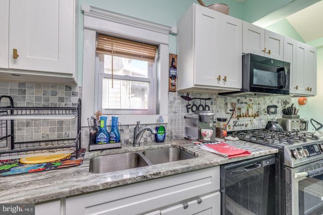 a kitchen with a stove a sink and a microwave