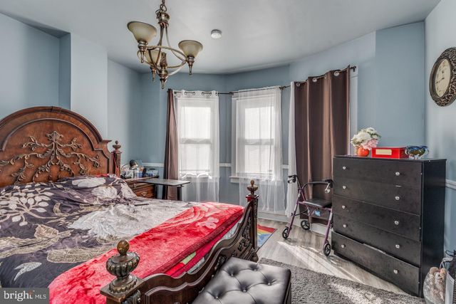 a bedroom with a bed dresser and a window