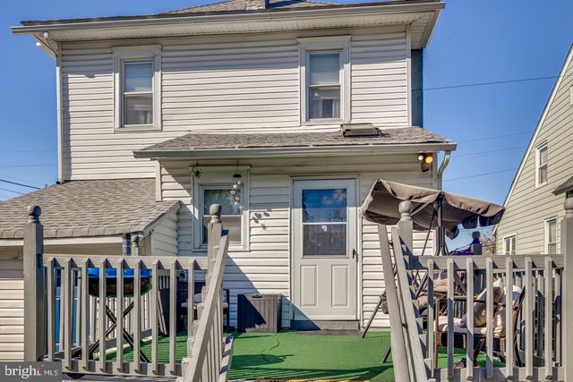 a view of a house with wooden fence
