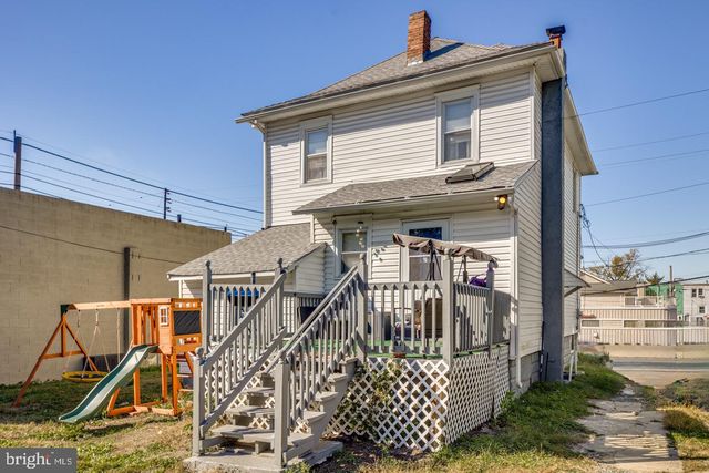 a view of a house with wooden fence