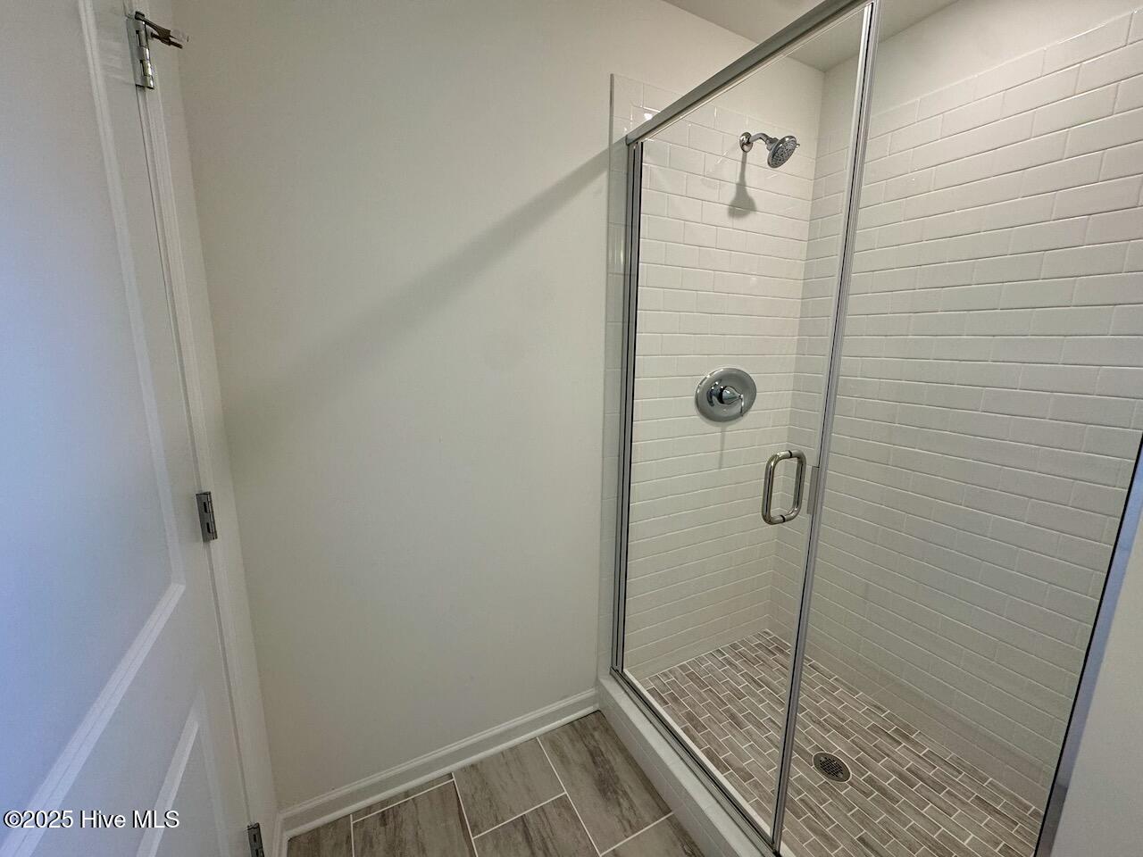 45 Covey Rise Way Lillington, NC 27546 - Photo 35 of 62 HIGHLIGHTS: Walk-In Shower with 3x6 White Subway Tile – Brick Laid Tile Walls and Costar Mount Claire Mosaic Ash Tile Floors, with Bright White Grout.