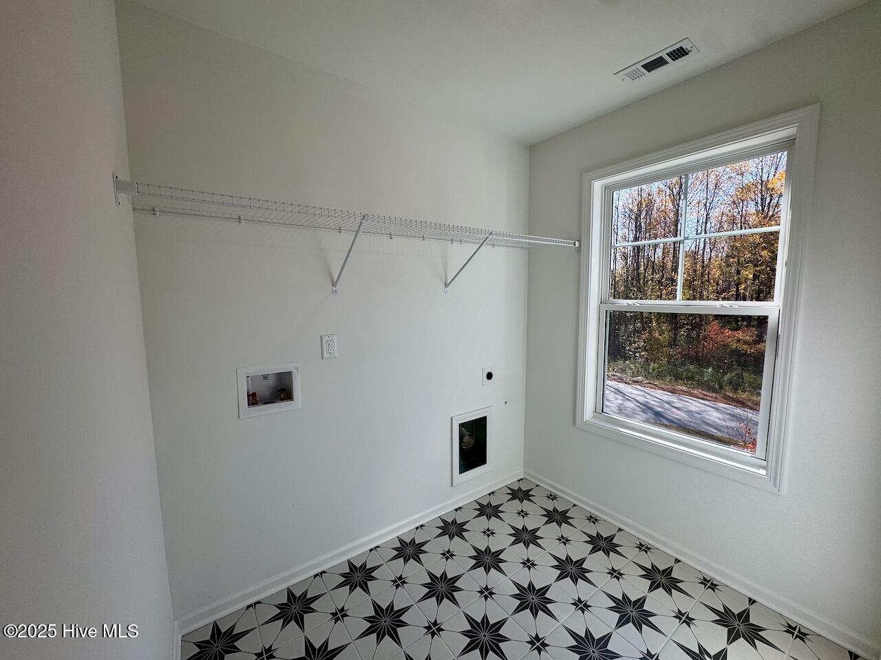 45 Covey Rise Way Lillington, NC 27546 - Photo 50 of 62 HIGHLIGHTS: Memoir – Jewel Black Tile on Floor with Frost Grout, Wire Shelving, and Washer/Dryer Hook-up. CONVENIENTLY LOCATED ON THE SECOND FLOOR!