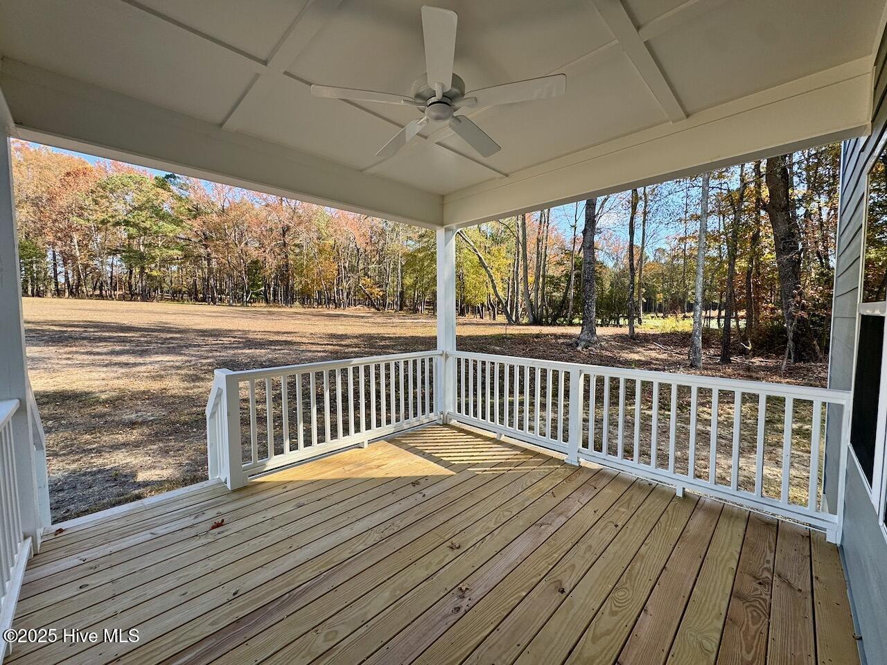 45 Covey Rise Way Lillington, NC 27546 - Photo 54 of 62 HIGHLIGHTS: Covered, Pressure Treated Wood Floors, Columns, and Railings, (Columns and Railings are also painted), Flood Light, and Upgraded Outdoor Ceiling Fan.