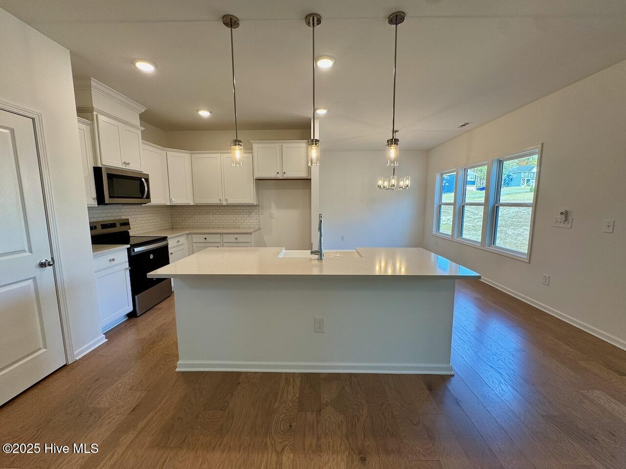 45 Covey Rise Way Lillington, NC 27546 - Photo 9 of 62 HIGHLIGHTS: Kitchen Island, Silestone Desert Silver Quartz Countertops, Pantry with Built-in Shelving, Farmhouse Sink, Tile Backsplash, Stainless Steel Appliances, Disc Lights, and Upgraded Pendant Lights Over Island.