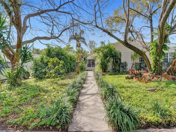 a view of a pathway of a house with a yard